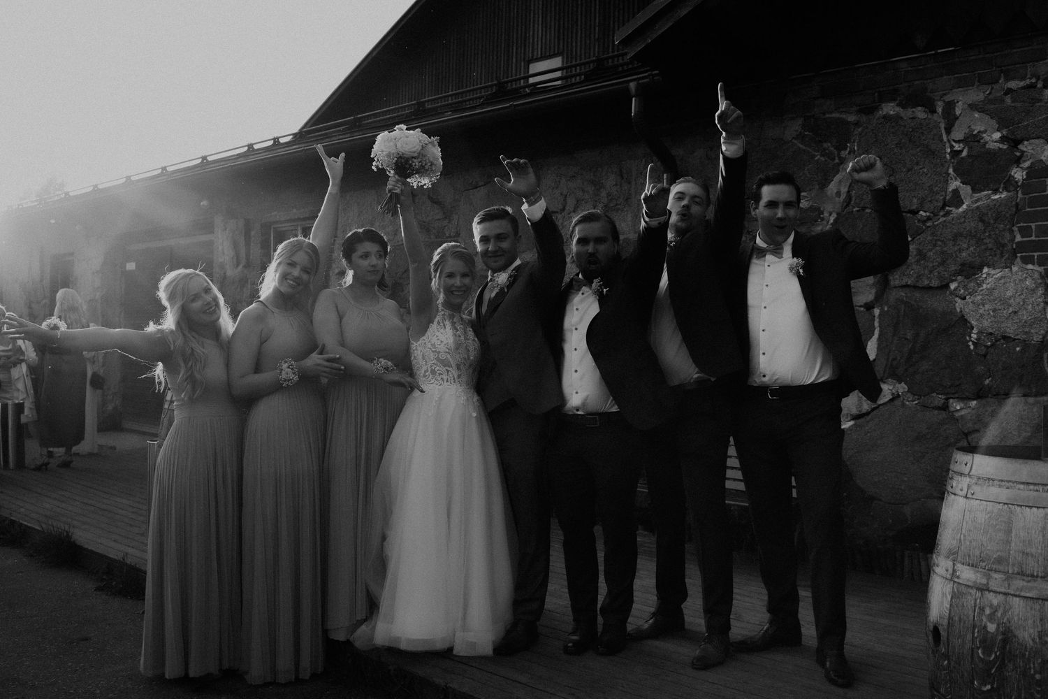 wedding group celebrating outdoors at Agroniksenmäen kellarin piha joyful documentary wedding photography Finland