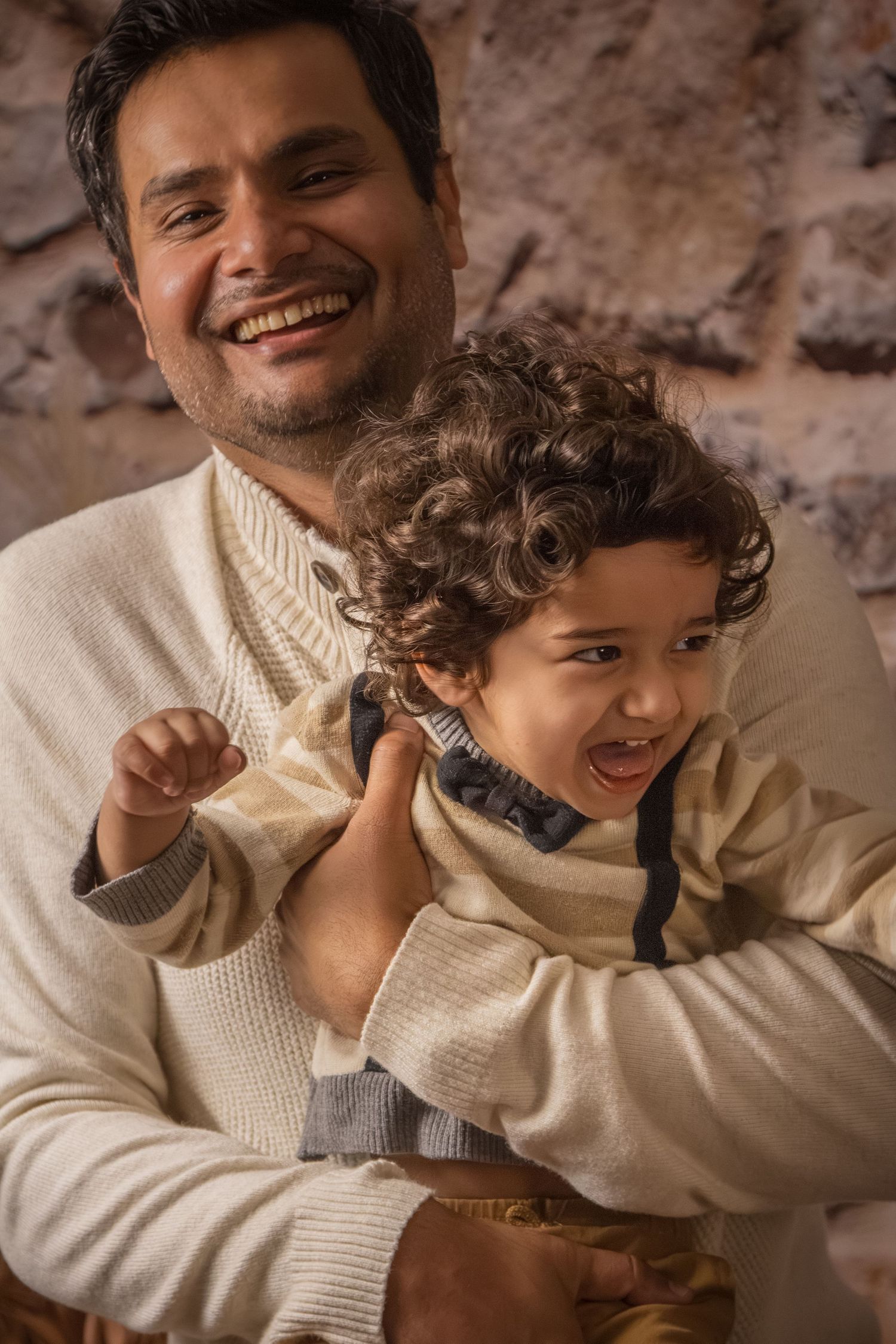 Family session with boho setup father holding smiling toddler boy Faily photographer mississauga