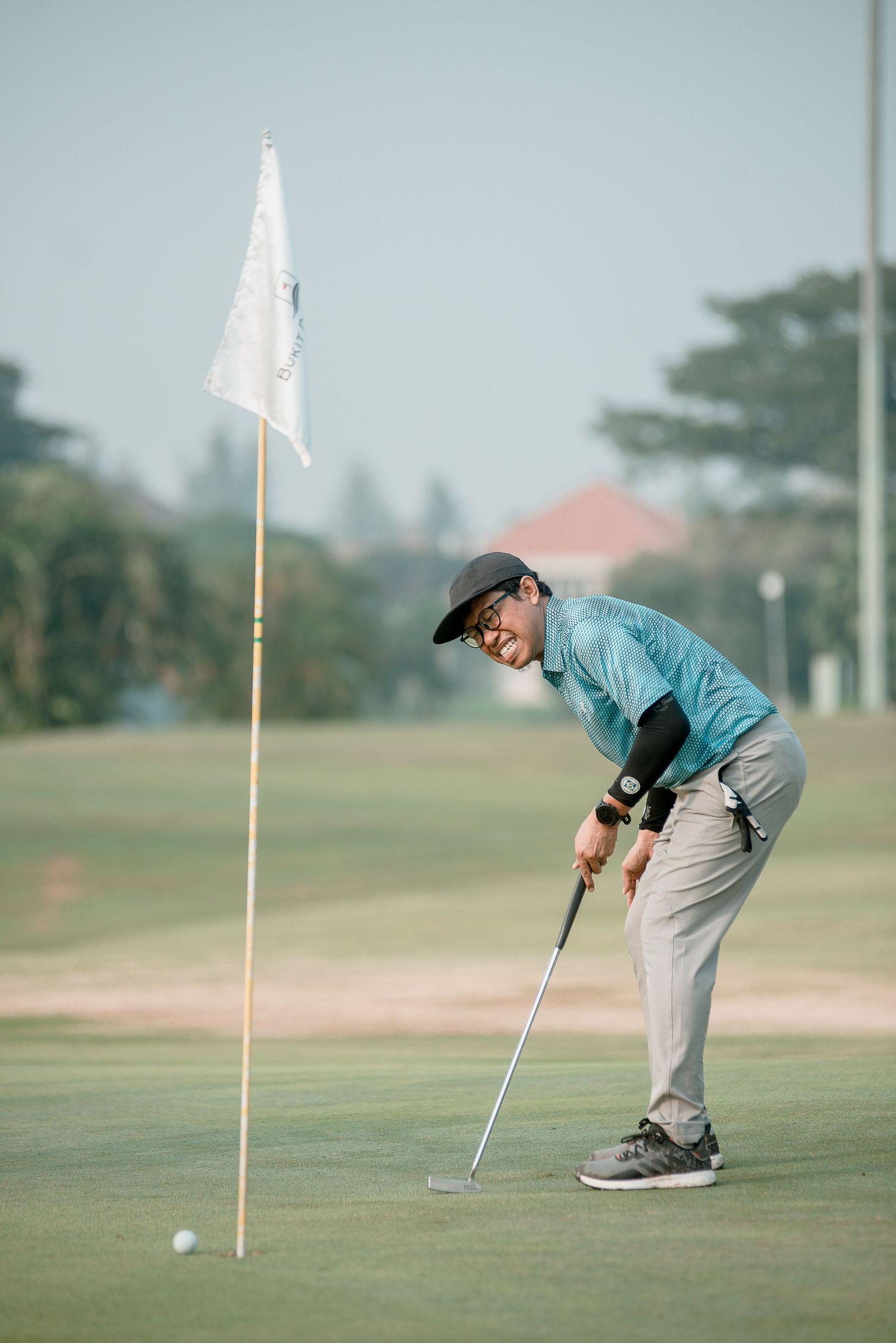 Sequence of golf putting shots showing golfer crouching down to analyze the green near white flag.