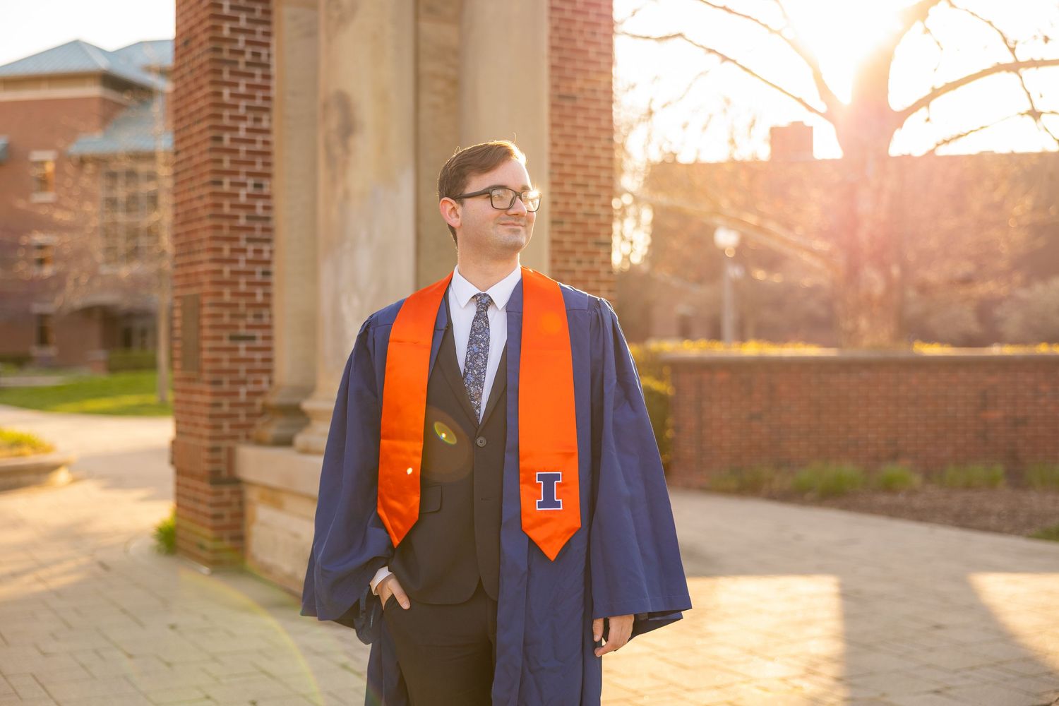 UIUC graduation photo of a guy looking into the distance with graduate attire on