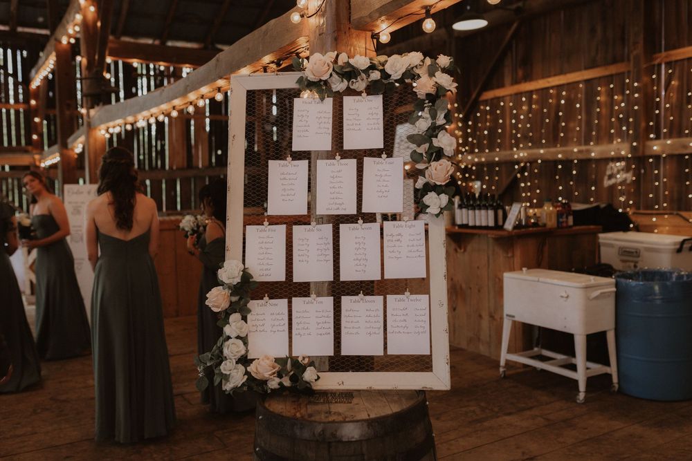 Wedding reception venue decorated with twinkling string lights and rustic wooden elements creating a warm ambiance.