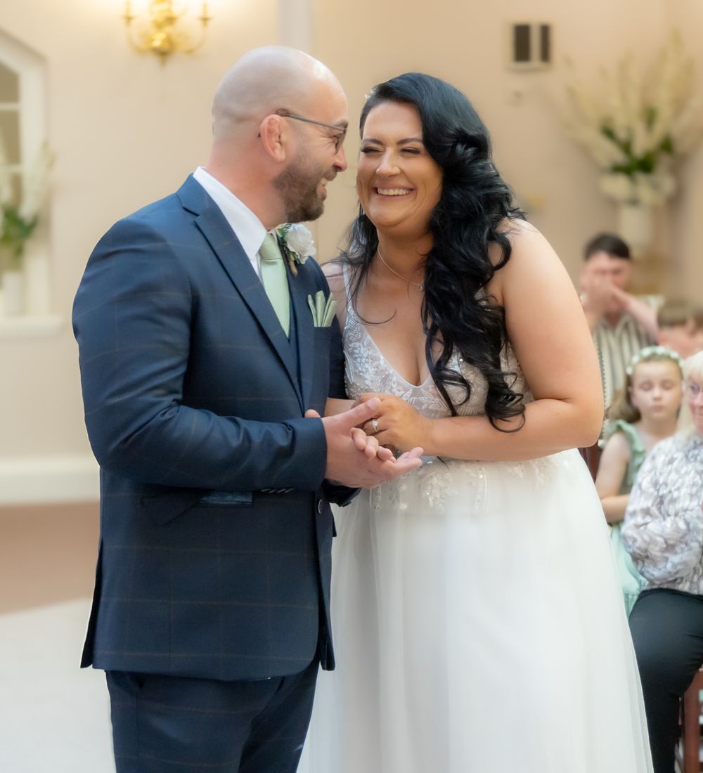 A couple shares their first dance together at an elegant indoor wedding reception.