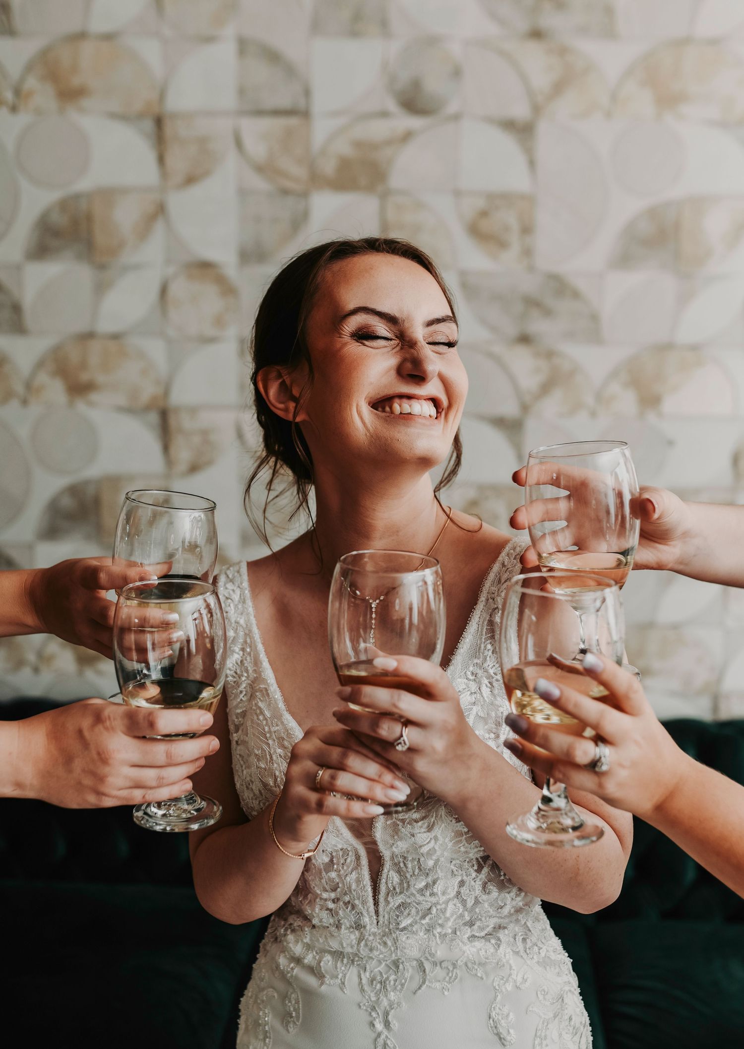 Bride celebrating with bridesmaids during a champagne toast in the bridal suite on her wedding morning in Dallas.
