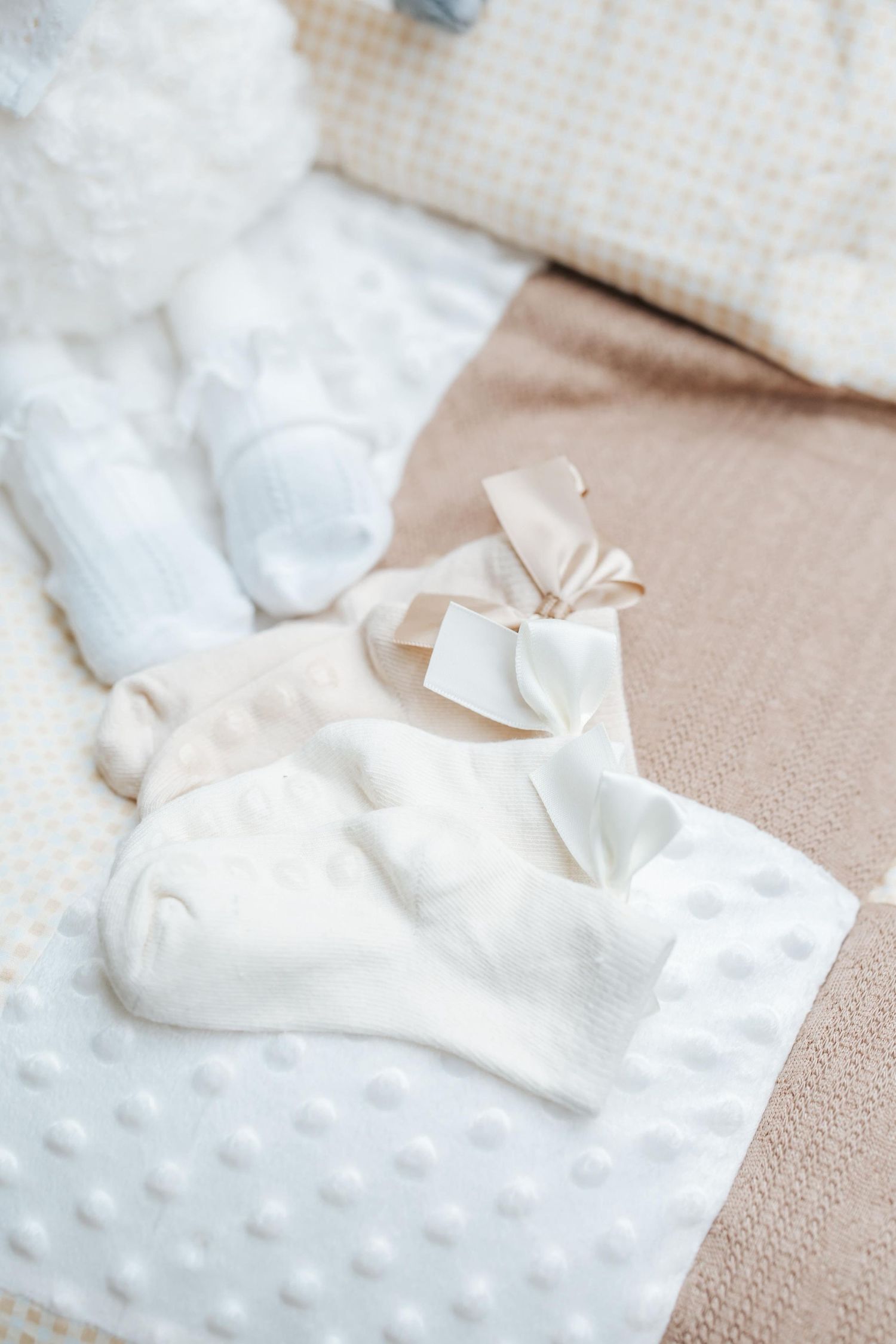 Close-up view of white tissue paper arranged in a decorative pattern on a textured beige surface.