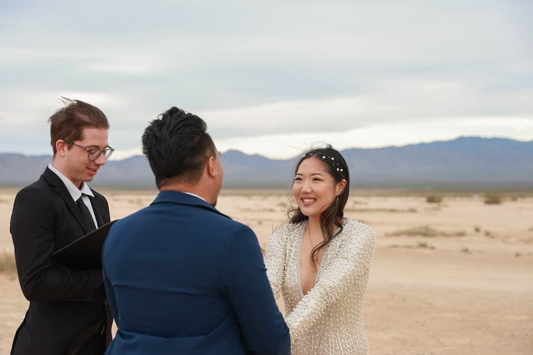 A couple shares intimate moments during their desert wedding photo session at sunset.