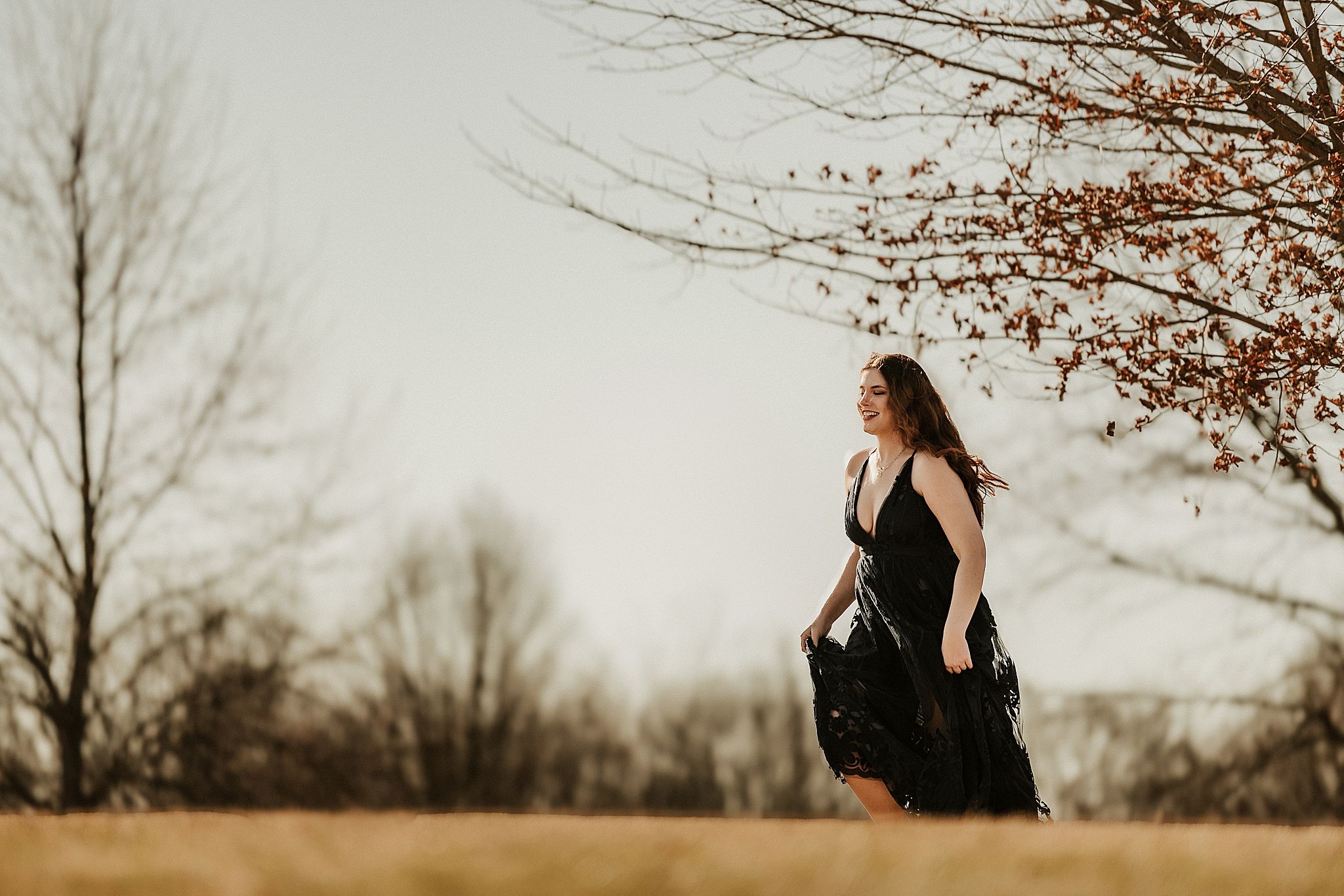 A series of photos showing a person in a black outfit walking through a winter landscape with bare trees.
