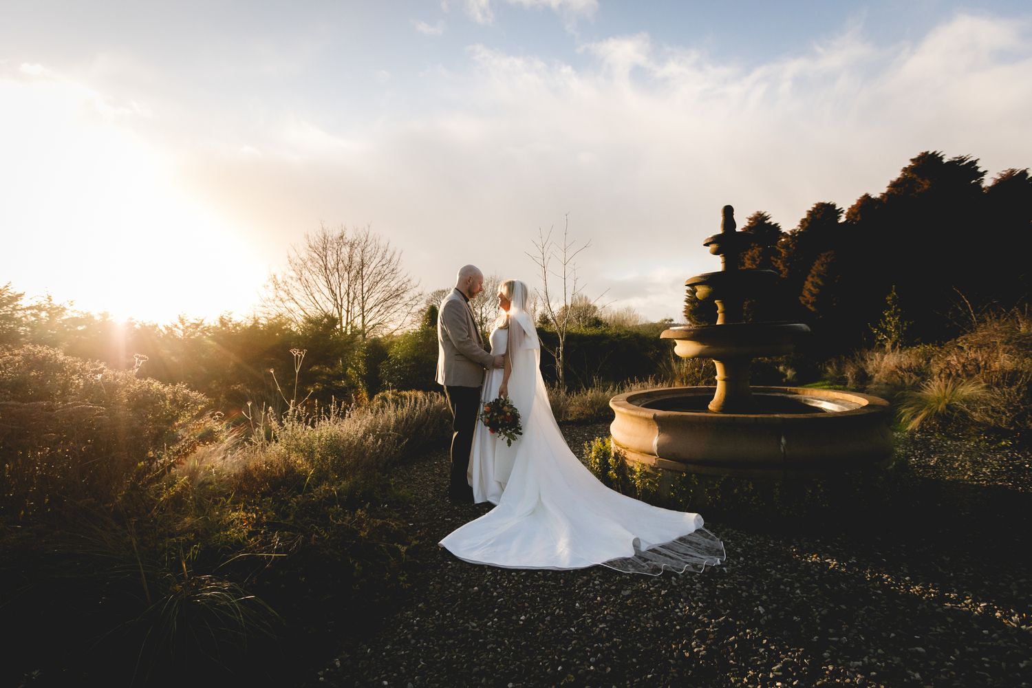 A panoramic wedding photo collage showing silhouettes against golden sunset light in a garden setting.