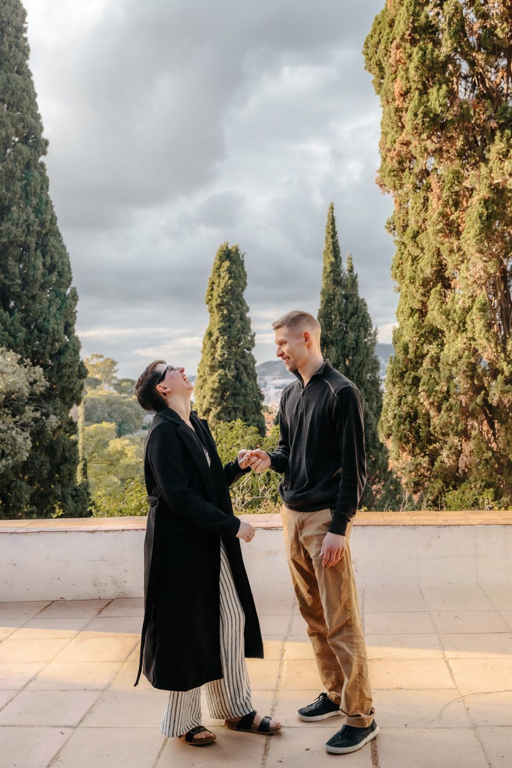 Loving couple framed by stone arches Barcelona Surprise proposal Barcelona BarcelonaLoversPH