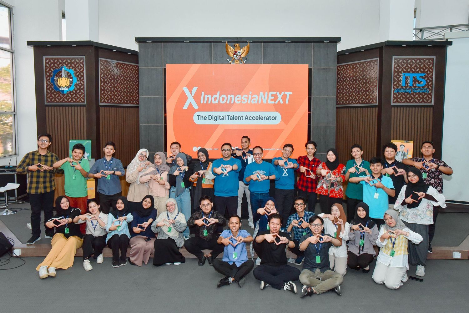 Group of tech enthusiasts and participants gathered at an IndonesiaNEXT event for a community photo session.