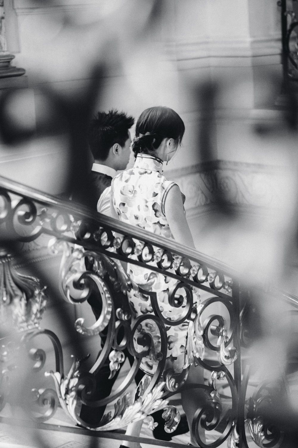 couple walking down ornate staircase during elegant engagement celebration at shangrila hotel paris