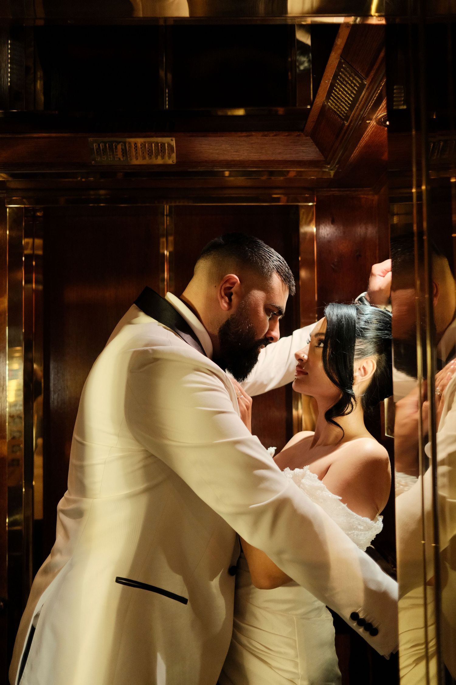 A romantic moment captured in dramatic lighting with wood paneled walls.