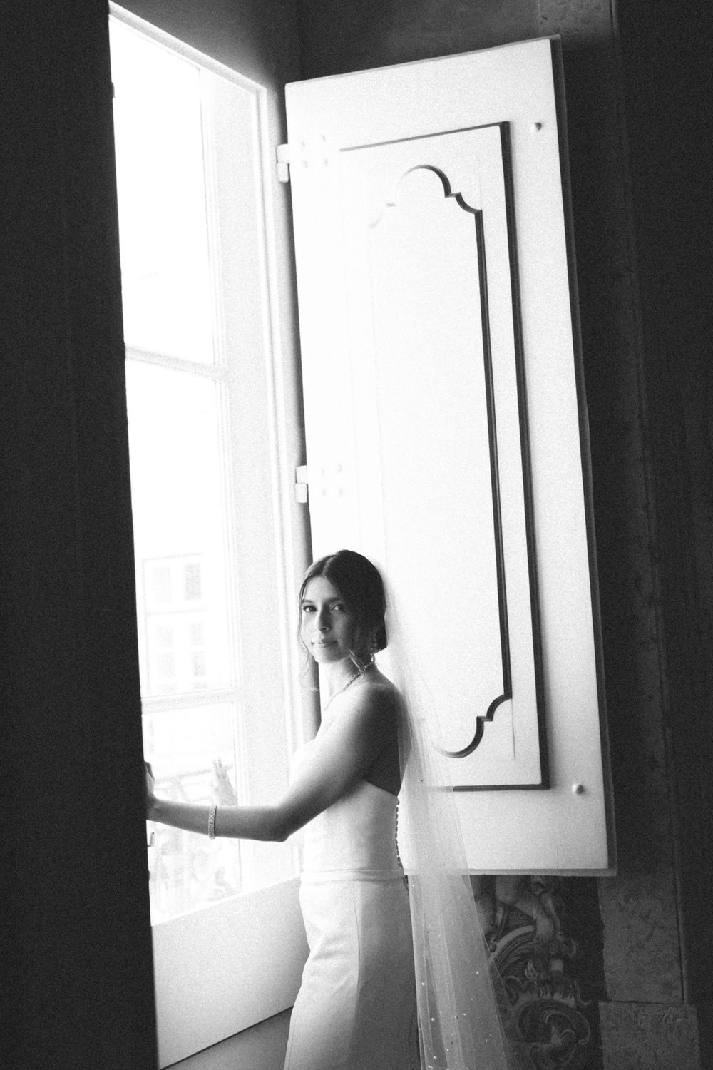Black and white bride portrait by window with veil, Palácio de Fronteira Lisbon wedding preparations