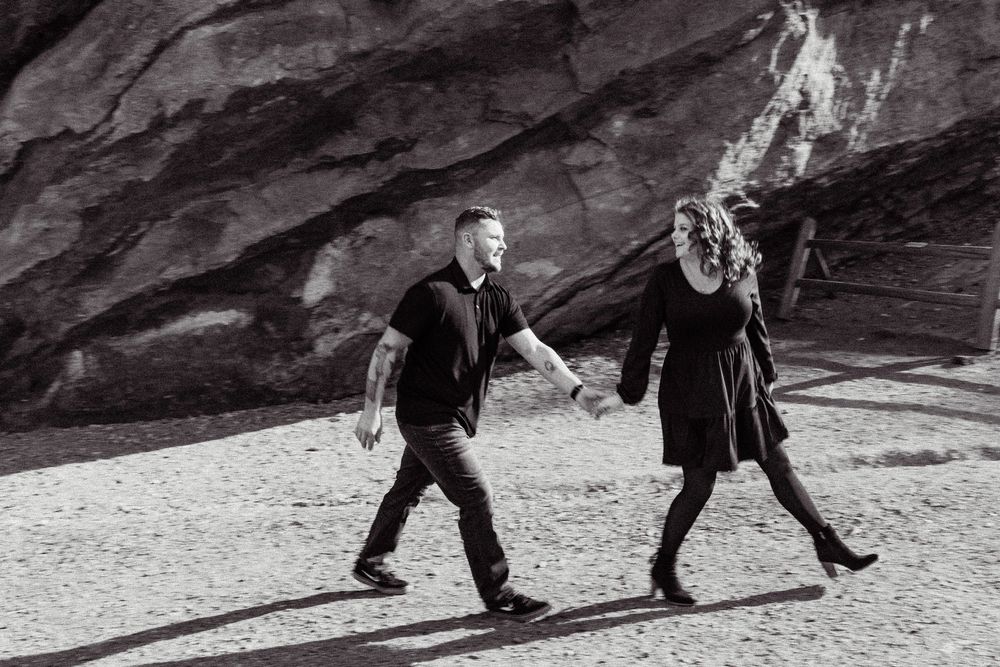 A sequence of black and white photographs showing people walking across a rocky desert landscape.