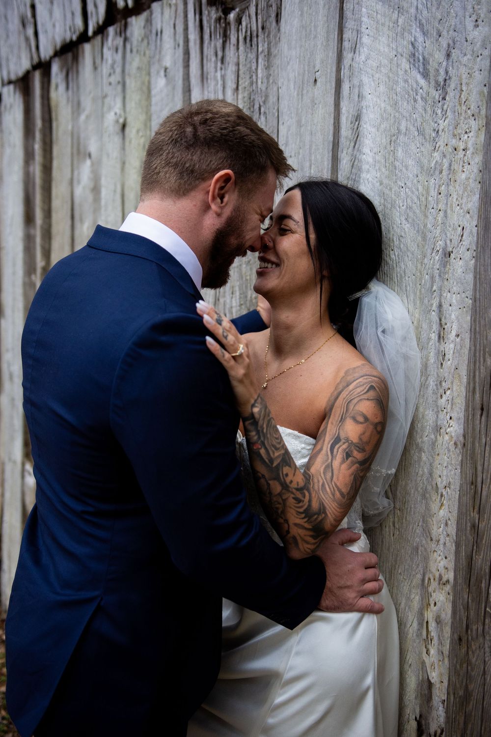 A romantic triptych showing a couple in wedding attire sharing intimate moments against a rustic wooden fence.