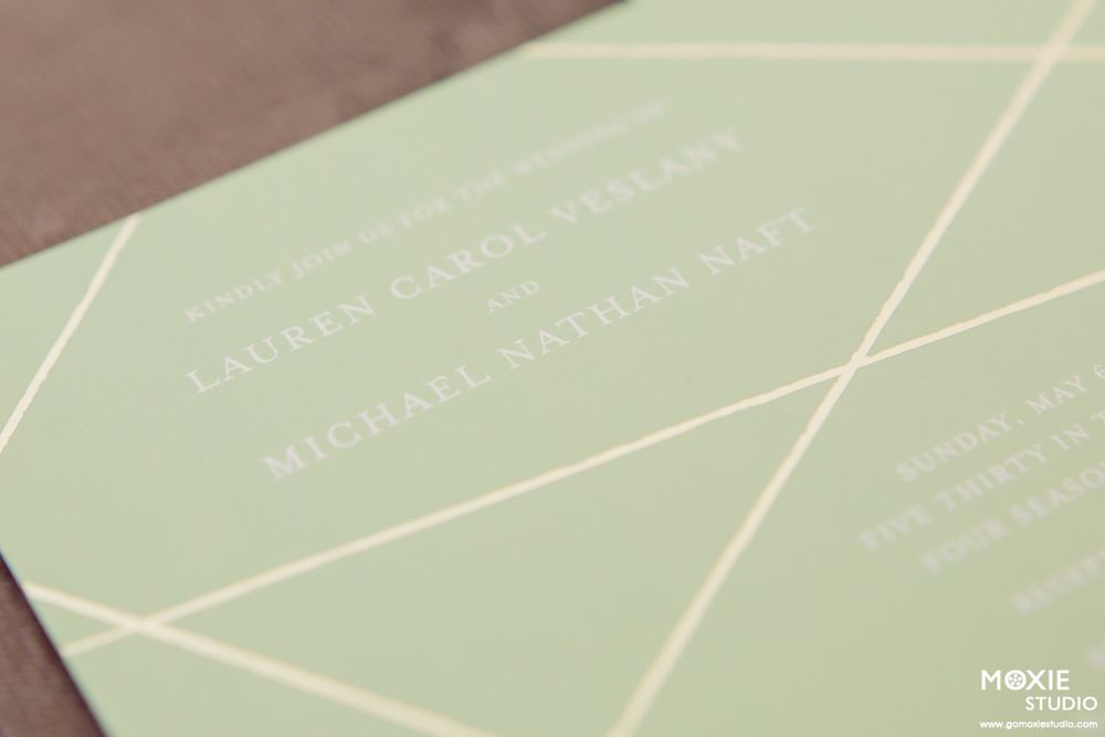 Mint green wedding invitation cards arranged in a gradient pattern showing elegant typography and design.