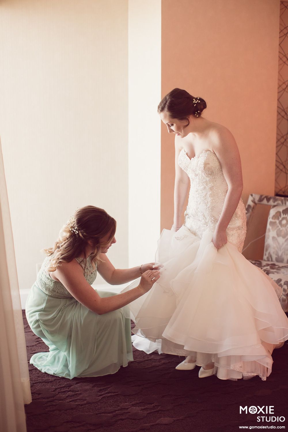 A series of photos showing someone adjusting the layers of a white wedding dress against a light background.