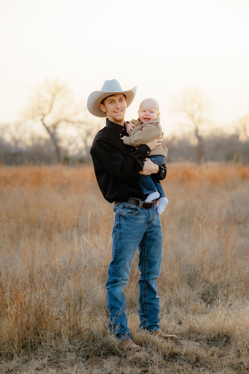 Dad holds baby son during for Enid family photos.