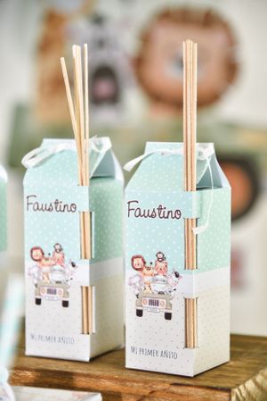 Two light blue decorative reed diffuser boxes with wooden sticks labeled 'Faustino' featuring cute car illustrations.
