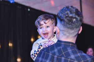 Joyful moment captured with bright lighting and celebratory atmosphere at an event.