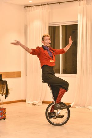 Person performing tricks on a unicycle in an indoor space.