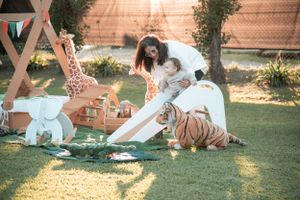 Outdoor party setup with lawn games and decorations in natural sunlight.