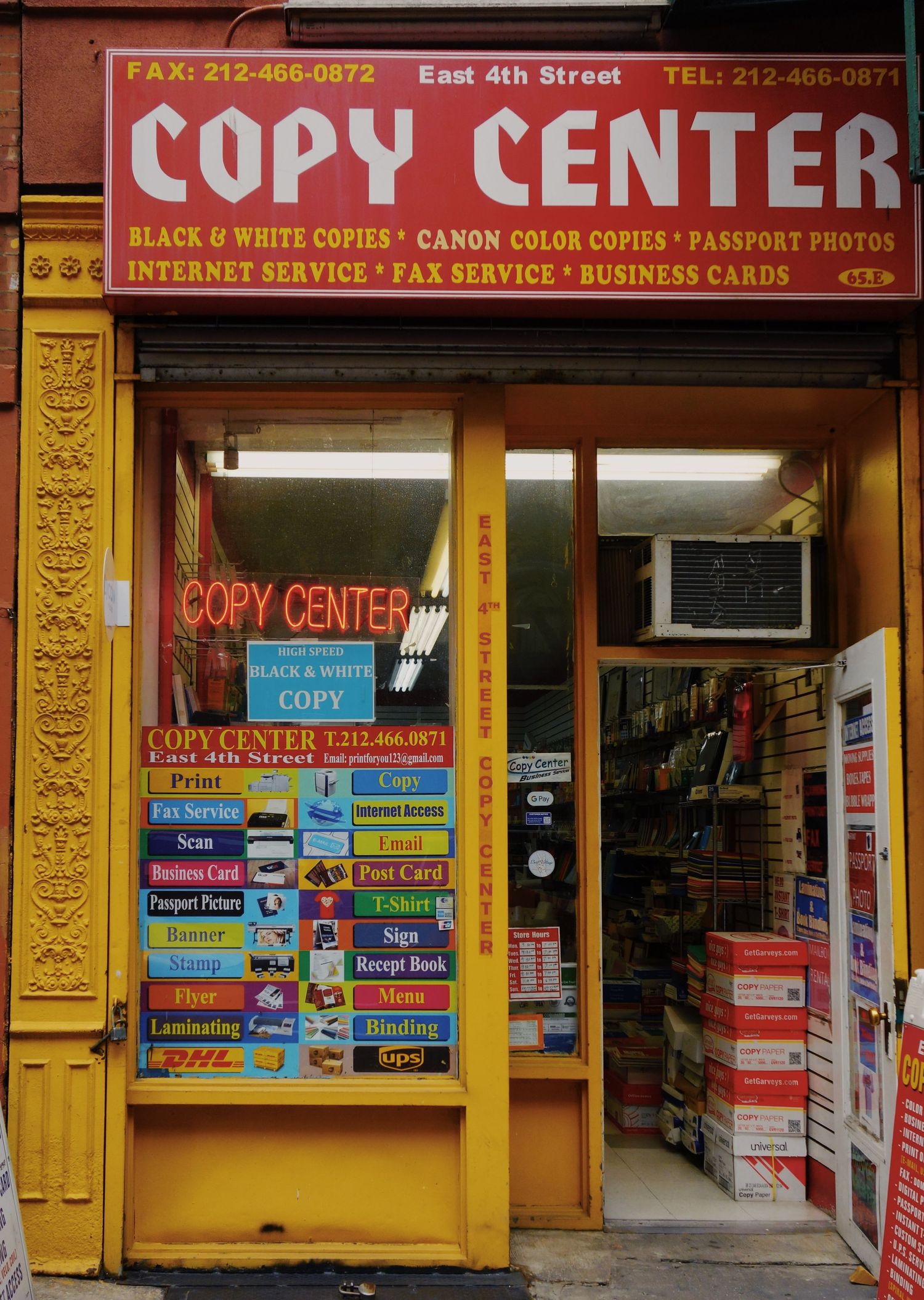 A colorful storefront of a Copy Center with yellow trim offering printing services, copies, and business cards on East 4th Street.