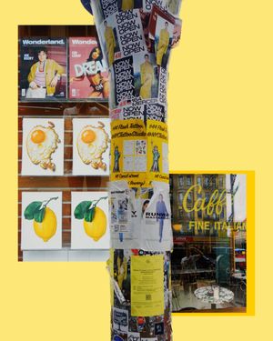 Urban street scene with posters showing food illustrations and a yellow background contrasted against a textured pole.