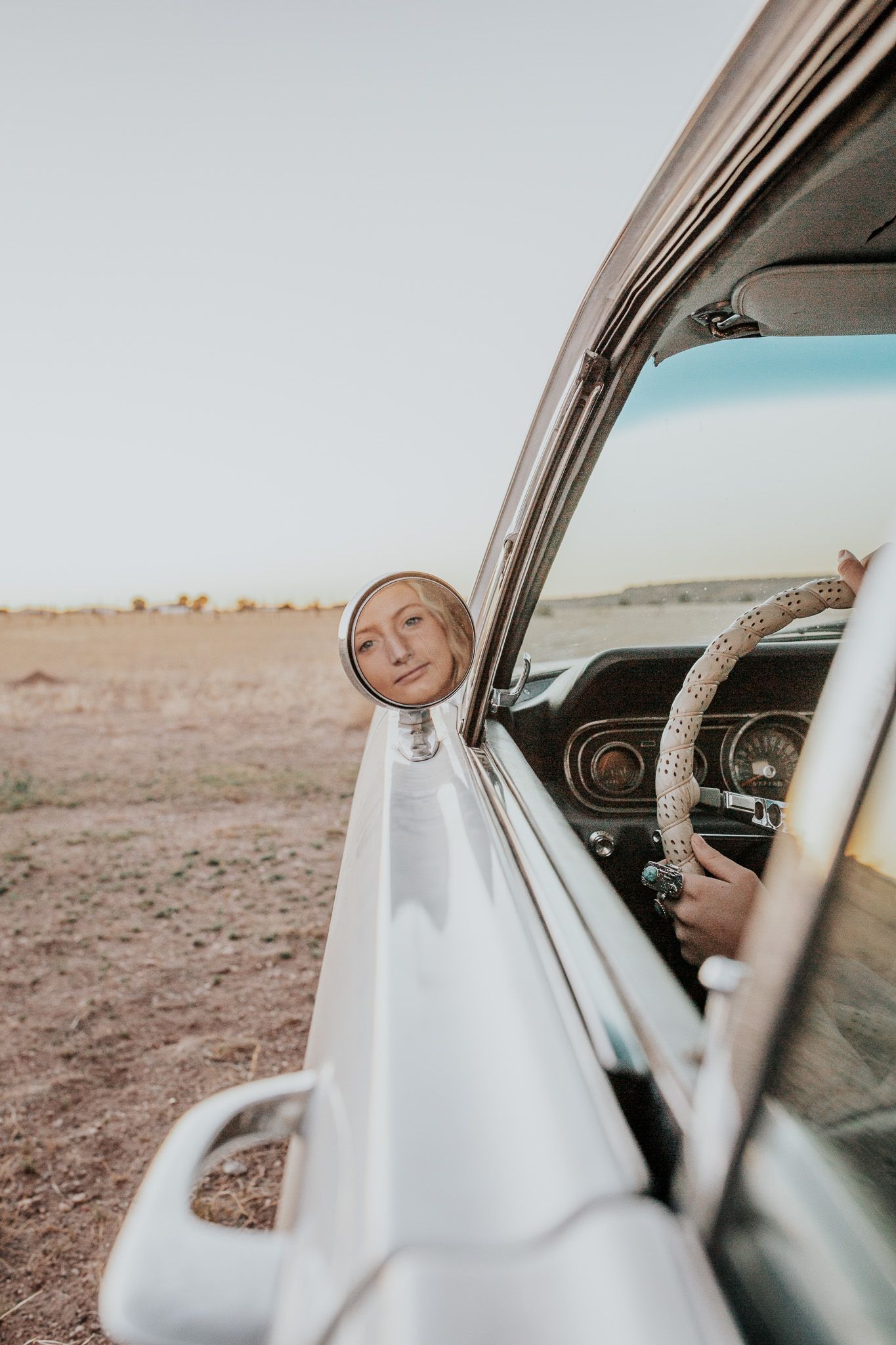 A dreamy vintage-style photo sequence showing someone driving a classic car through a desert landscape.