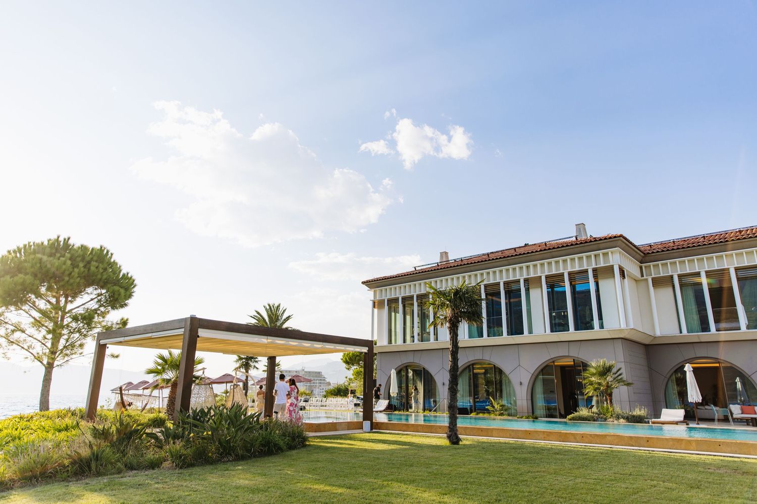 Luxury Mediterranean villa with swimming pool and landscaped garden overlooking sunny coastal views.