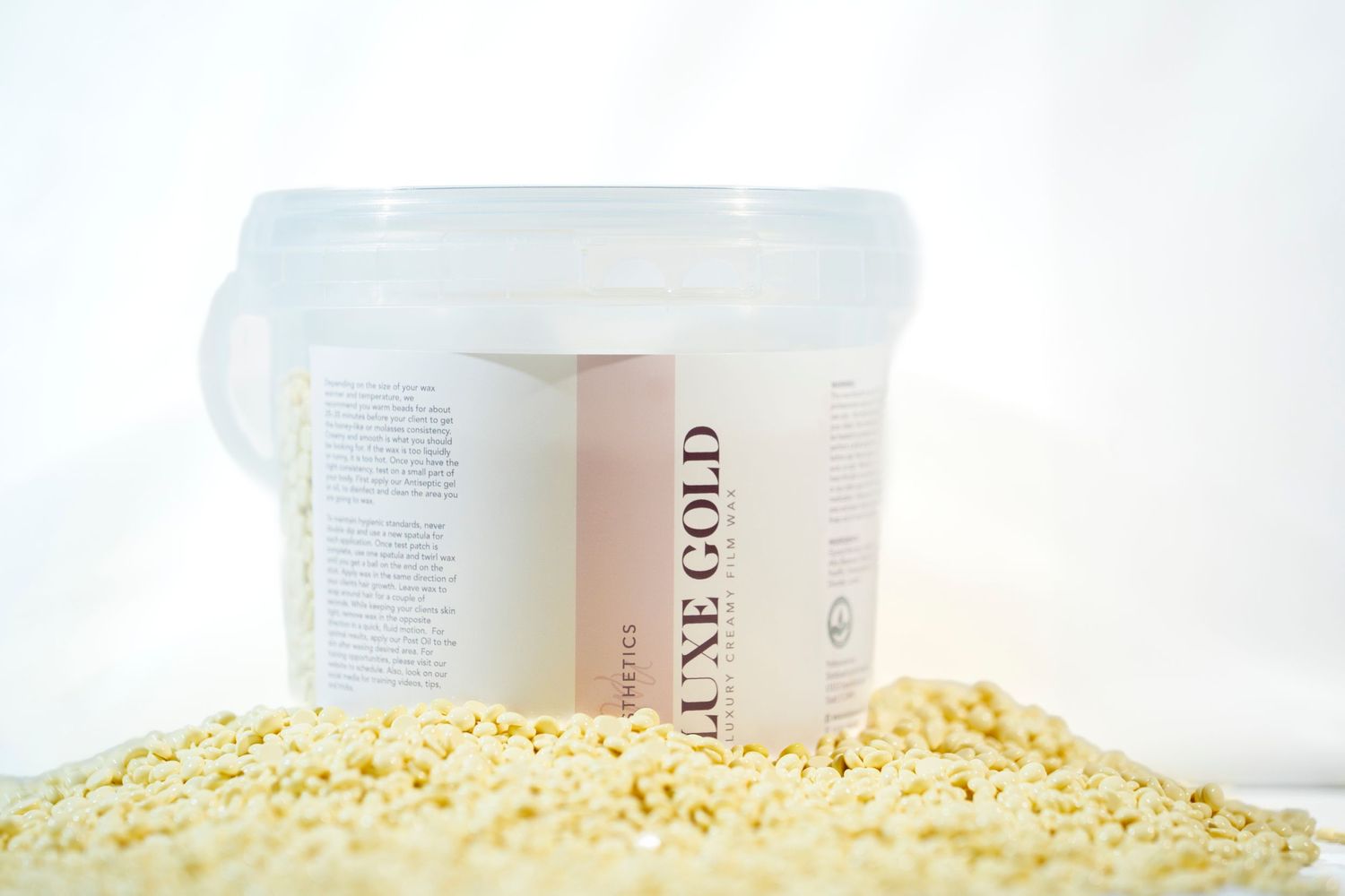Product shot of a container surrounded by yellow granules on white background.
