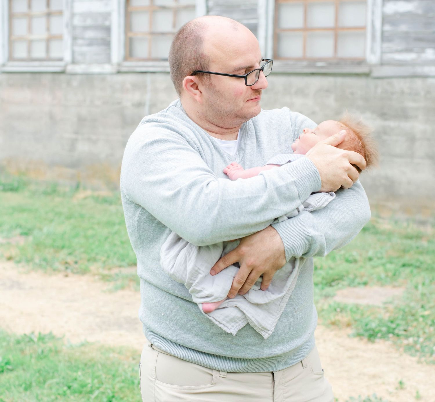 Playful outdoor family moments captured on a gray stone building background.