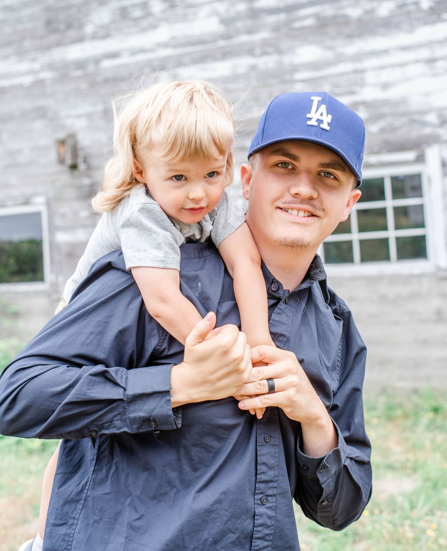 Candid family moments shared while wearing LA Dodgers cap outdoors.