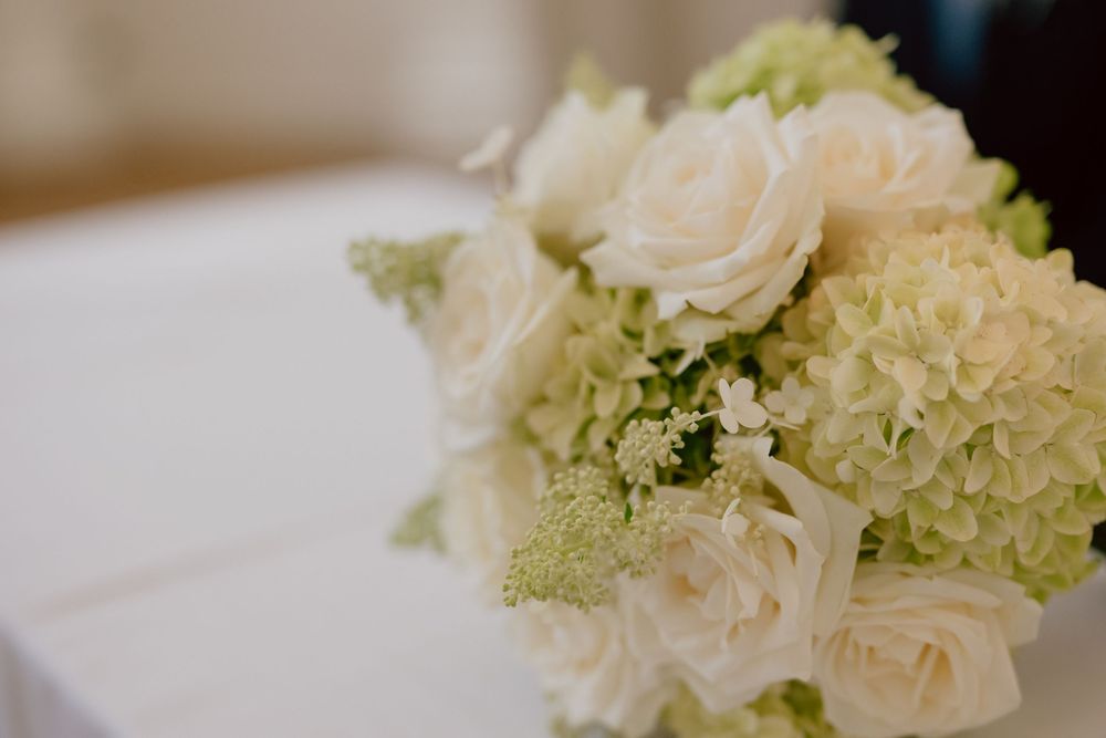 Elegant wedding bouquet of white roses and green hydrangeas arranged beautifully for a bridal ceremony.