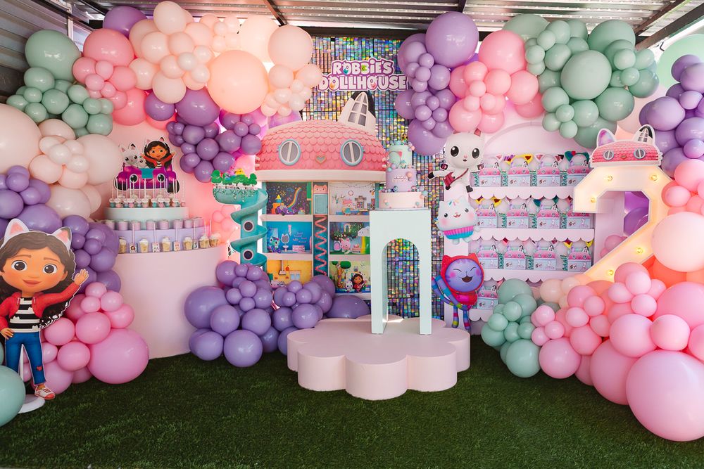Full backdrop decor with a beautifully presented cake stand, creating a magical Dollhouse-inspired setting.