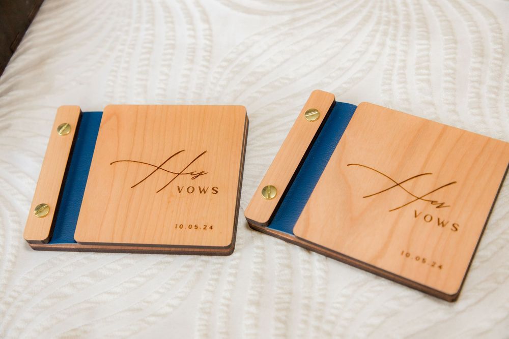 Personalized wooden His and Her vows books with blue resin accents engraved with a wedding date.
