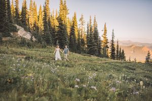 Engagement couple kissing together during their couples adventure photo session in Mt. Rainier National Park near Seattle Washington