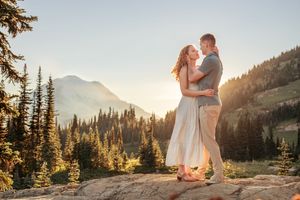 Engagement couple kissing together during their couples adventure photo session in Mt. Rainier National Park near Seattle Washington
