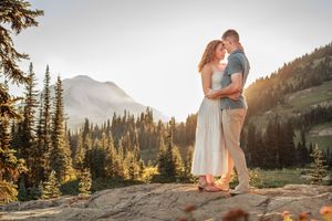 Engagement couple kissing together during their couples adventure photo session in Mt. Rainier National Park near Seattle Washington