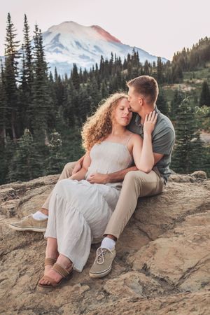Engagement couple kissing together during their couples adventure photo session in Mt. Rainier National Park near Seattle Washington