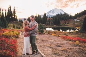 Couple hiking and traveling to Mt. Rainier and standing together during a family photoshoot in Mt. Rainier National Park in Washington