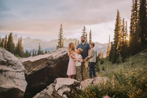 Family hiking and traveling to Mt. Rainier and standing together during a family photoshoot in Mt. Rainier National Park in Washington