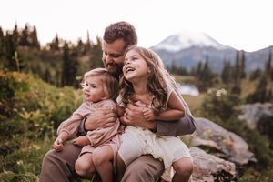 Dad and children together during their adventure and family photoshoot at Mt. Rainier National Park near Seattle, Washington