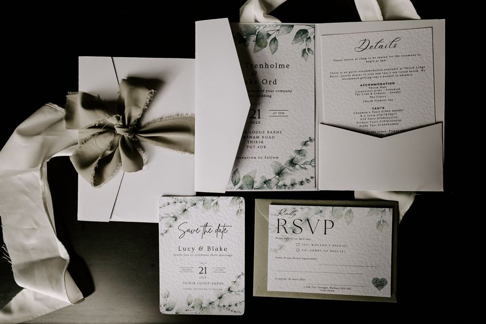 A collection of elegant wedding invitation cards and RSVP cards arranged in a collage with black and white tones.