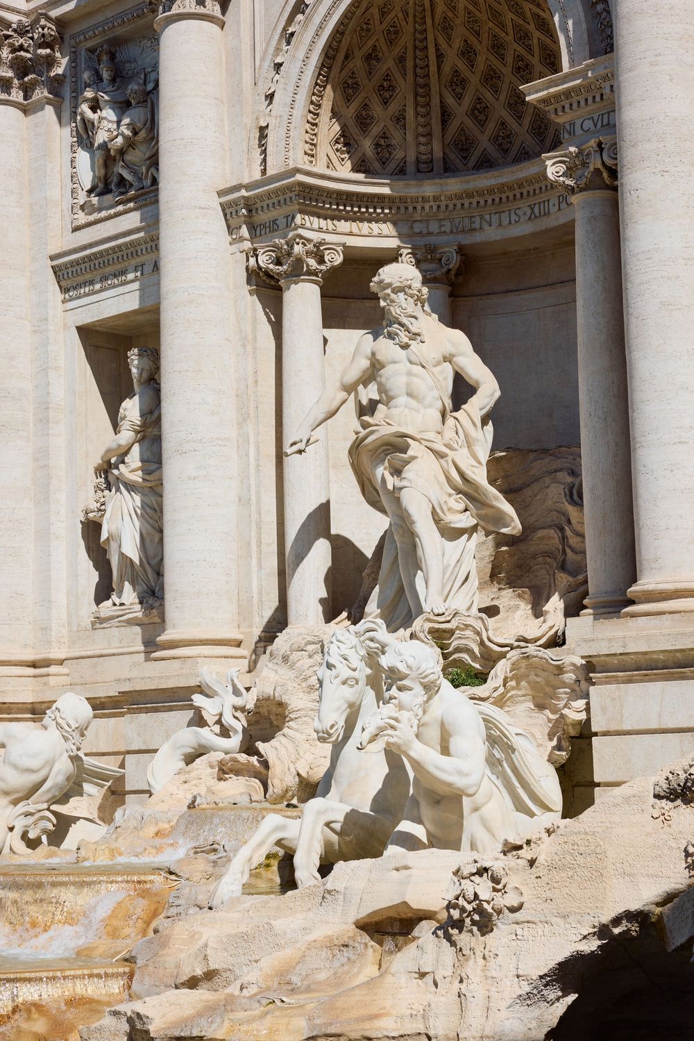 Majestic Trevi Fountain sculptures in Rome featuring Neptune statue with ornate baroque architecture.