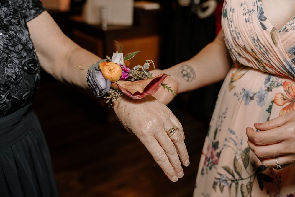 Close-up shot of hands during a romantic dance at an indoor celebration.