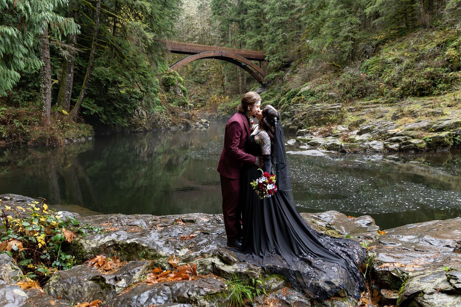 Bride and groom eloping at Moulton Falls in Washington State. Bride in Black Lace Dress.