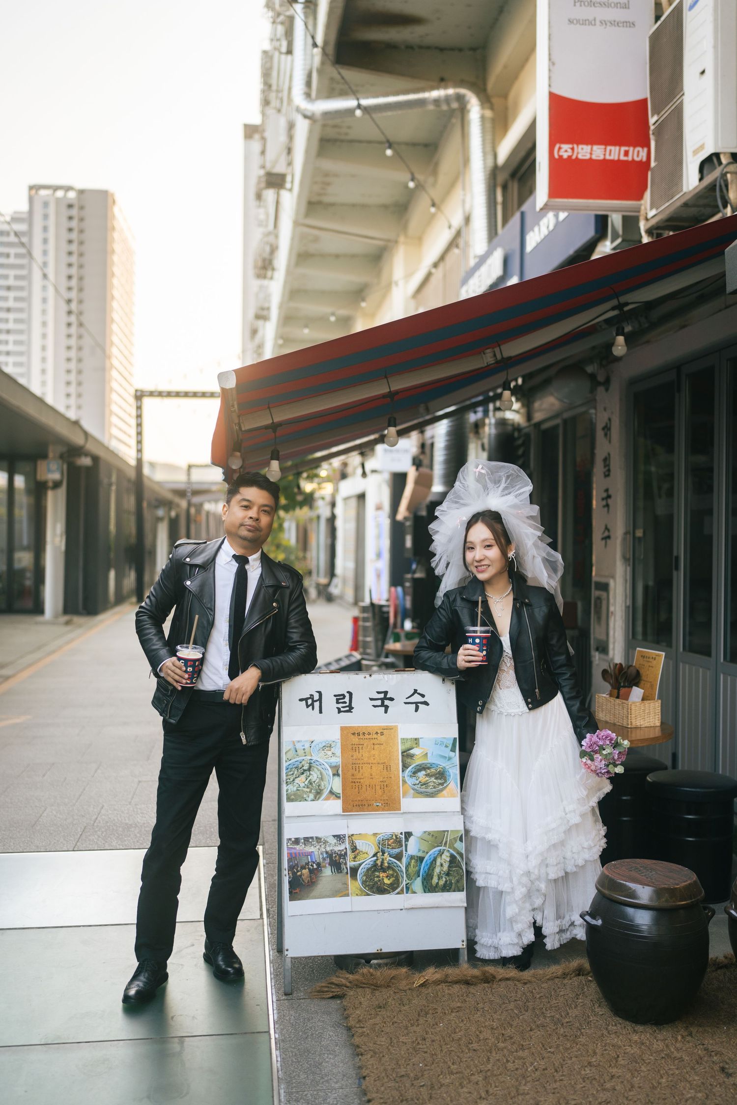 A series of wedding photos showing a couple posing in front of a storefront with Korean signage.
