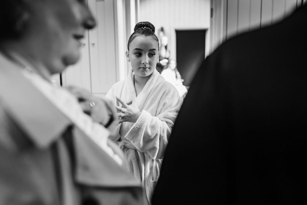 A black and white photo montage showing candid moments at a wedding celebration with people interacting and laughing.