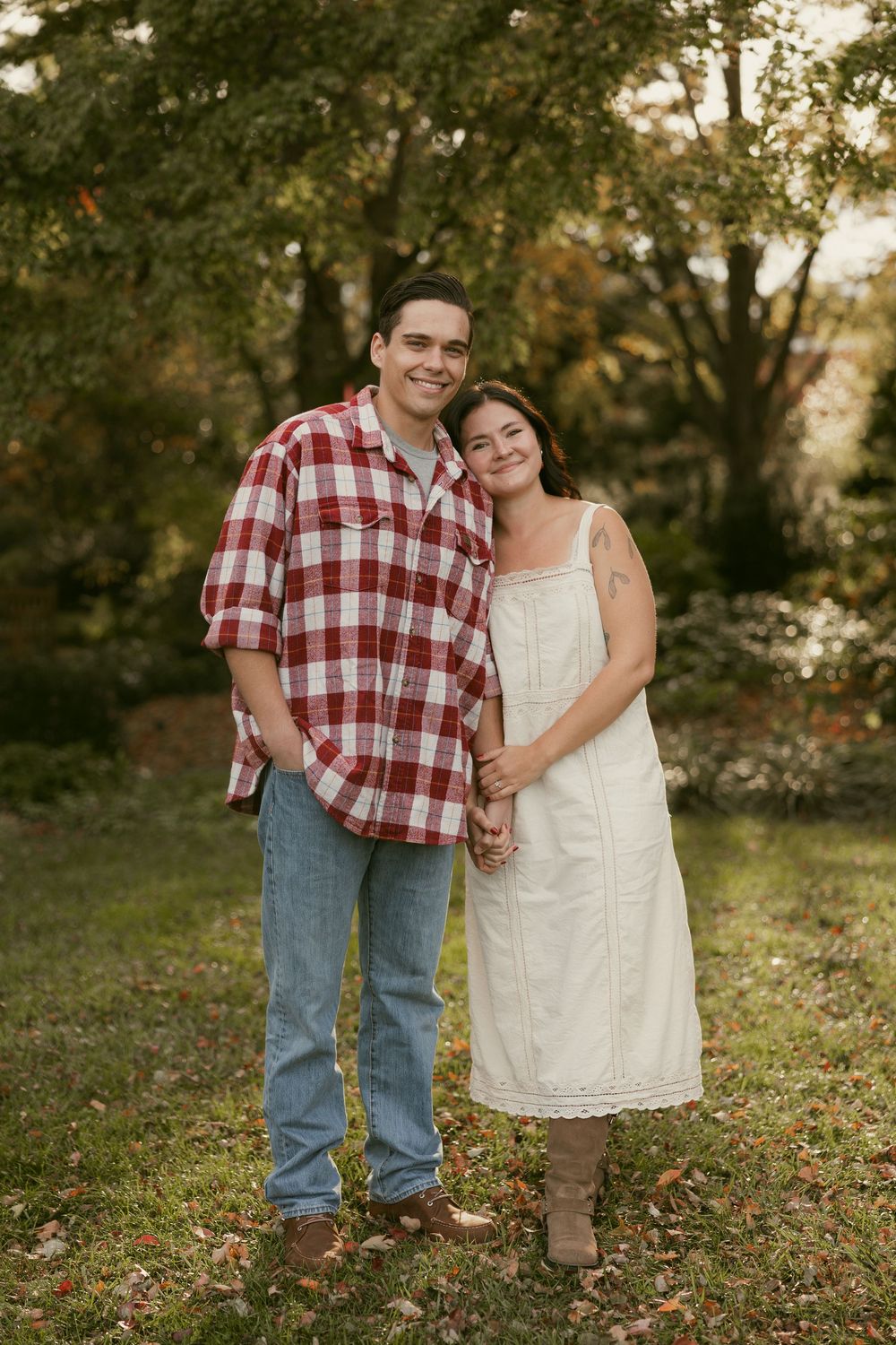 Casual outdoor couple photos in a rustic setting with fall foliage.