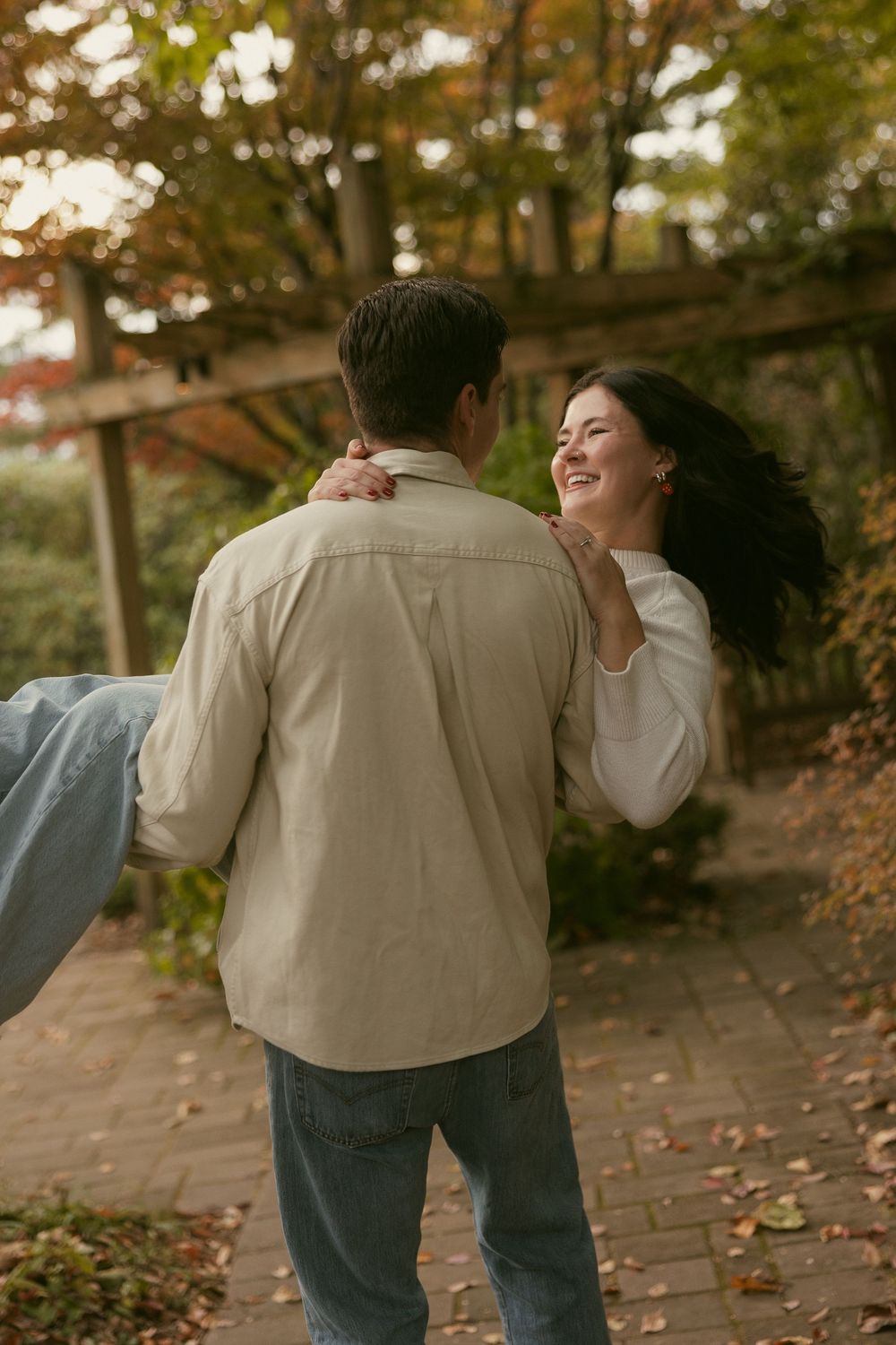Candid moments captured during a fall photo session showing joyful interaction and laughter.